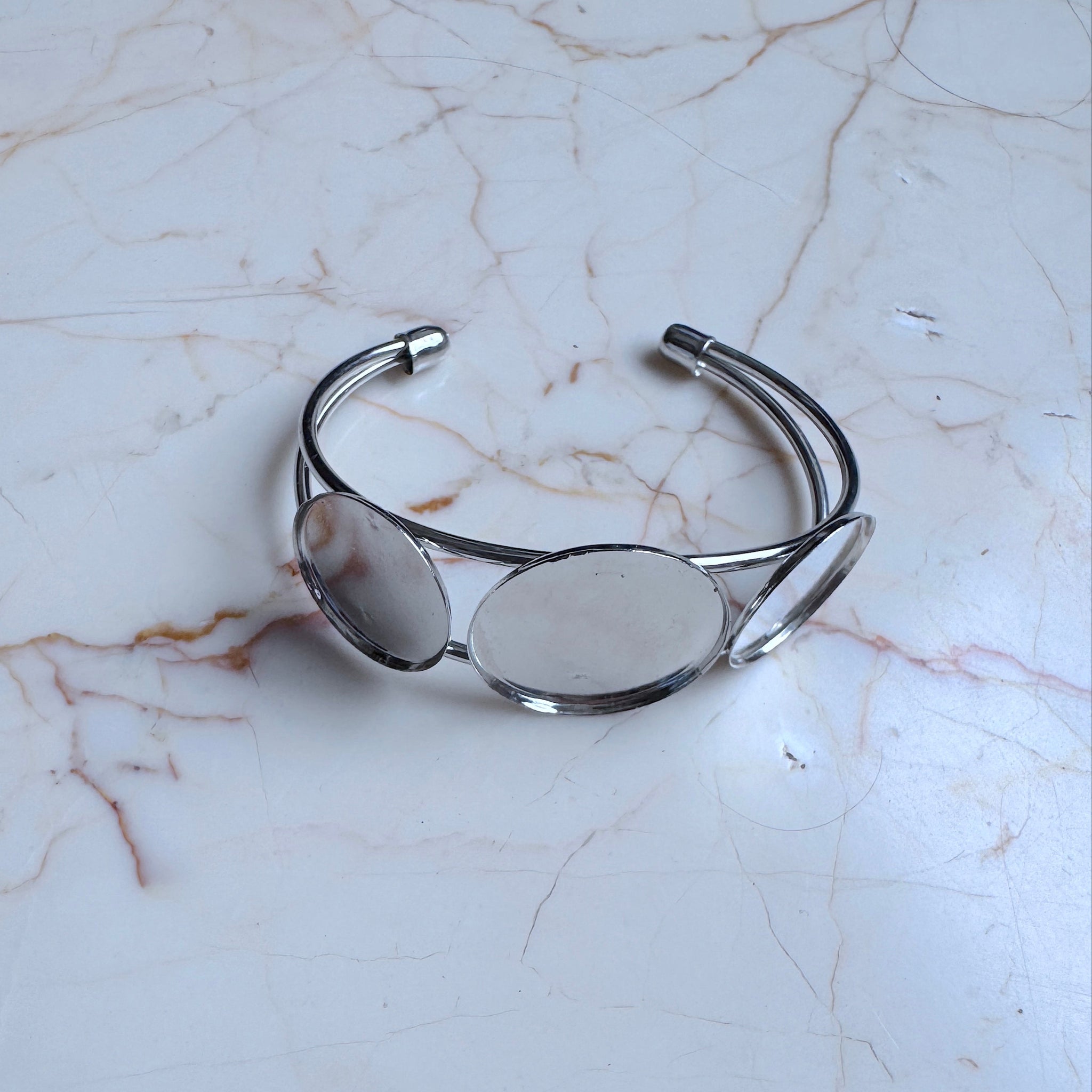 Silver bracelet on a marble surface