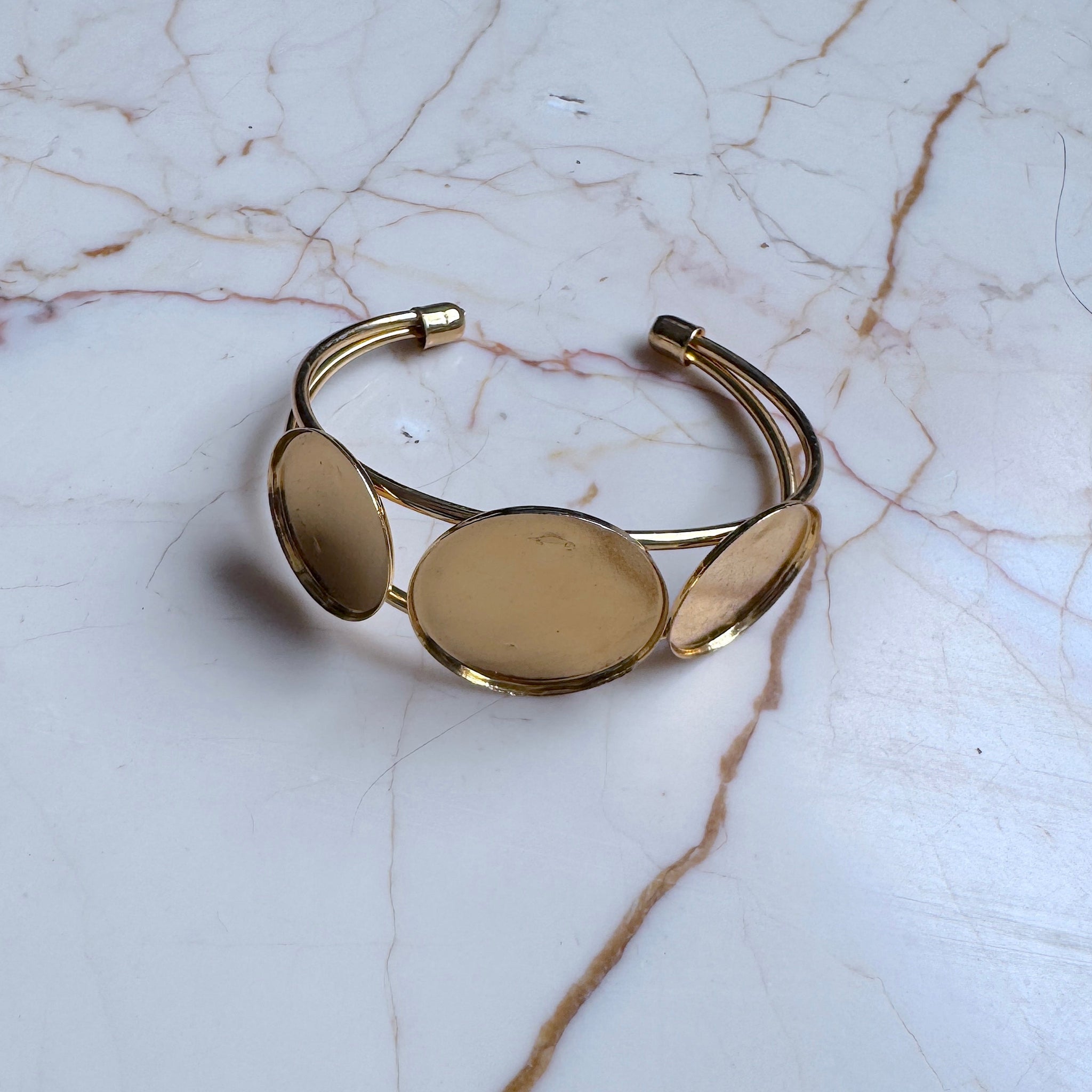 Gold bracelet on a marble surface
